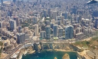 An aerial view of Beirut, Lebanon, showing the Mediterranean coastline and Raouche Rocks, for custom travel packages by White Sky Travel.