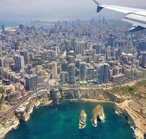 An aerial view of Beirut, Lebanon, showing the Mediterranean coastline and Raouche Rocks, for custom travel packages by White Sky Travel.