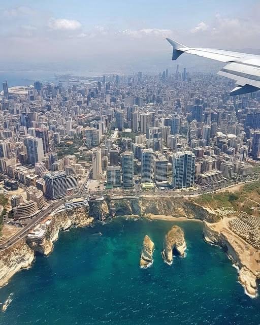 An aerial view of Beirut, Lebanon, showing the Mediterranean coastline and Raouche Rocks, for custom travel packages by White Sky Travel.